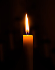 Burning candle on a black background (Candle flame)