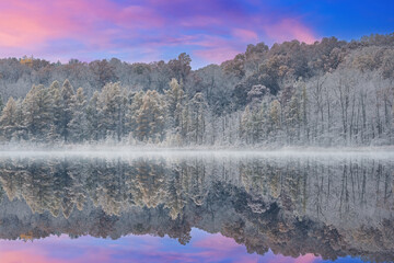 Wall Mural - Foggy autumn landscape of the shoreline of Deep Lake flocked with snow and with mirrored reflections in calm water, Yankee Springs State Park, Michigan, USA