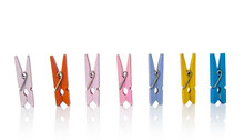 Multicolor Plastic Clothespins On A White Background