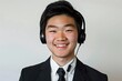 a 22-year-old asian man wearing a black and white suit, half-length portrait, wearing a headset