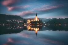 Assumption Of Maria Church In The Middle Of Lake Bled And Illuminated Cityscape At Night, Bled, Slovenia