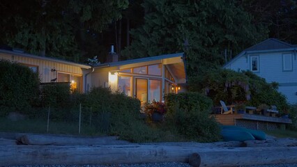 Wall Mural - Establishing shot of two story stucco luxury house with big tree and nice landscape at night in Vancouver, Canada, North America. Night time on Apr 2023. ProRes 422 HQ.