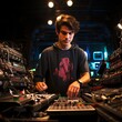 © Molang Visual - A young male audio engineer in a black hoodie works at a soundboard during a live event.