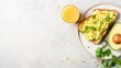 Fresh avocado toast with scrambled eggs and juice, perfect for a healthy breakfast