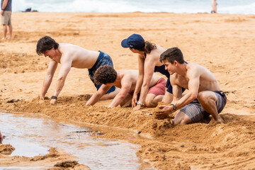 a family playing in the sand