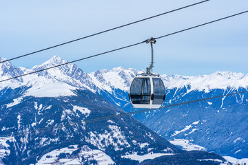 Wall Mural - Cable car gondola against snow covered Dolomites inn Kronplatz in the winter, South Tyrol, Italy