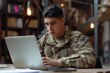 young military man using his laptop writing
