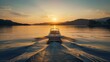 A picturesque golden-hour moment captured in this stunning stock photo. The serene boat gracefully glides through calm waters as the setting sun illuminates the sky with warm hues, evoking a