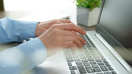 Close-up of a business woman's hands working on a laptop keyboard. A programmer writes code using a computer. Typing.