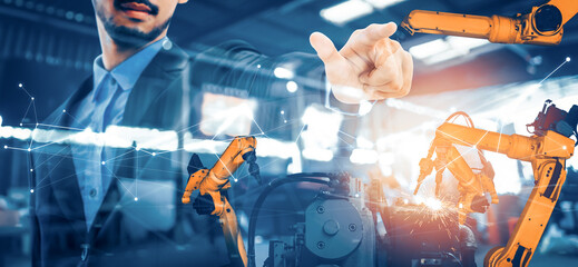 Wall Mural - XAI Mechanized industry robot arm and factory worker double exposure. Concept of robotics technology for industrial revolution and automated manufacturing process.