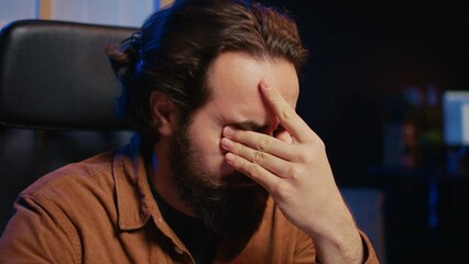 Disappointed computer scientist puzzled after being unable to remove all bugs while coding on workstation desktop. Teleworking IT specialist confused by troubling script errors, camera B close up