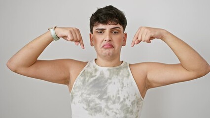 Sticker - Depressed young man in sleeveless t-shirt looking sad, standing alone, pointing down, indicating the direction. upset expression over isolated white background