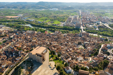 Scenic drone view of two parts of Spanish town of Fraga divided by Cinca river and joined by bridges on sunny spring day, province of Huesca, Aragon