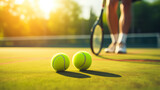 Fototapeta Sport - Tennis player with rackets and tennis balls on the grass court, outdoor sports
