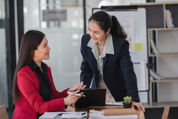 Wall Mural - Young beautiful Asian businesswomen working together in the modern office room.