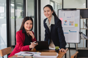 Wall Mural - Young beautiful Asian businesswomen working together in the modern office room.