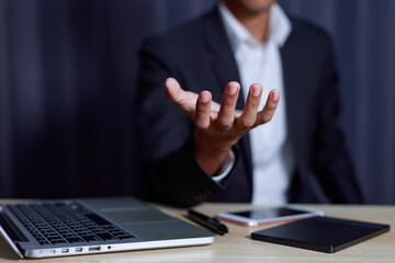 Businessman doing web conference and showing open hand gesture In the business office..