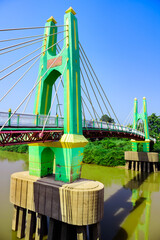 Canvas Print - Green suspension bridge across Nan River at Chum Saeng District