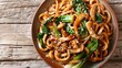 Asian vegetarian food udon noodles with baby bok choy, shiitake mushrooms, sesame and pepper close-up on a plate. horizontal top view