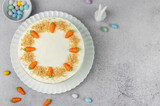 Fototapeta Storczyk - Homemade Easter carrot cake made with walnuts, iced with cream cheese. Sweet dessert.