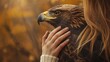 Young woman's hand hugging an eagle