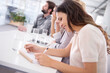 © Y.A./peopleimages.com - Business woman, smile and writing for meeting, diary and copywriter for account project in office. Professional female person, coworkers and notebook for company, read and conference room strategy