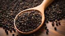 Aromatic Black Pepper On Wooden Spoon. Closeup Of Whole Black Pepper Spice With Kitchen Background