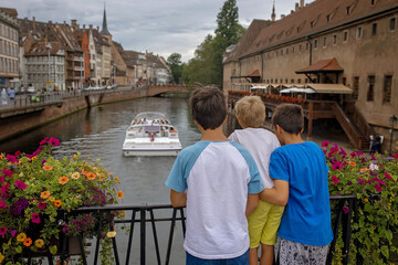 Wall Mural - Beautiful family with children, boys, visiting Strasbourg during summer vacation