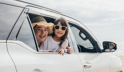 Wall Mural - Car insurance. Father, mother and children girl smiling having fun sitting in compact white car look out window blue sky, Summer at beach, Family holiday vacation travel, car travel, Happy family day