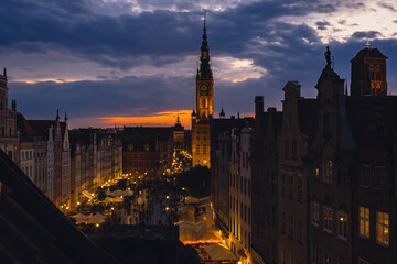 Wall Mural - Beautiful old town in Gdansk at summer dusk Poland. Sunset night view from the window rooftop on historical centre Dluga street and city hall architecture buildings St Mary Basilica. Travel attraction