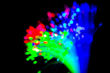 Wall Mural - Close up of blurred light fiber optics for communication technology network