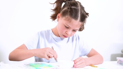 Canvas Print - Young Girl Engrossed in Crafting with Colorful Clay Beads