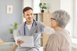 © Studio Romantic - Young happy doctor, male nurse and old woman talking, supportive hand, taking social care. Man monitoring female resident of nursing home, patient in hospital, clinic, maintain elderly health, safety