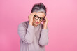© deagreez - Photo of sad exhausted tired woman hand touch temples suffering migraine symptom syndrome feel unwell isolated on pink color background