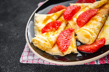 Wall Mural - Crepe grapefruit citrus pancakes tasty fresh eating cooking appetizer meal food snack on the table copy space food background rustic top view