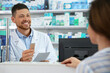© New Africa - Professional pharmacist working with customer in drugstore