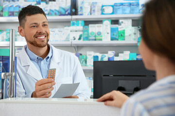 Wall Mural - Professional pharmacist working with customer in drugstore