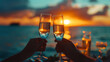Romantic silhouette of a couple at sunset, their love story etched against the fiery sky. Couple in love drinking champagne wine on a romantic dinner at sunset on the beach