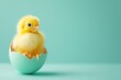 Adorable Yellow Chick Perched in Half an Eggshell Against a Soft Teal Background