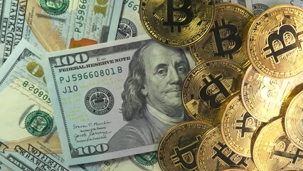 Wall Mural - Bitcoin gold coins on banknotes of 100 hundred dollars close up rotating background. Bitcoin all-time high new record. Cryptocurrency, b-roll, BTC. Digital currency and dollar competition concept.