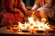 Hindu couple performs wedding rituals around a sacred fire during their wedding ceremony.