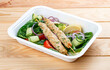 Chicken lula kebab with herbs and vegetables. Healthy food. Takeaway food. On a wooden background.