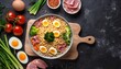 Fragrant instant noodles on a cutting Board with vegetables, ham and egg. On dark rustic background