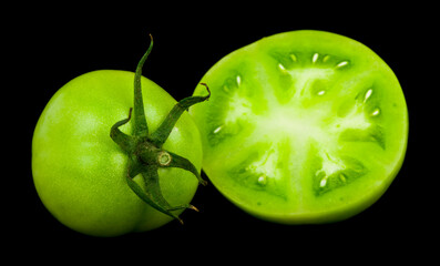 Wall Mural - Green tomatoes isolated on black background.