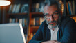© PrismCraft - Business portrait - businessman using laptop computer in office, thinking. Happy middle aged man, entrepreneur working online. .