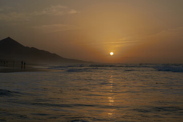 Wall Mural - Sunset on Cofete beach in Fuerteventura in Jandia Natural Park with silhouettes and mountains