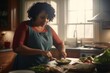 A large African American woman in an apron is cutting vegetables in the kitchen.