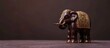 Golden indian elephant on table Decorative elephant statue Small elephant Little brown and gold decorative feng shui statuette of elephant. with copy space image. Place for adding text or design