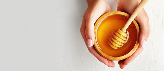 Aufkleber - Female hands holding a bowl of bee honey and a wooden spoon Close up Elaboration of organic soap based on glycerin. with copy space image. Place for adding text or design