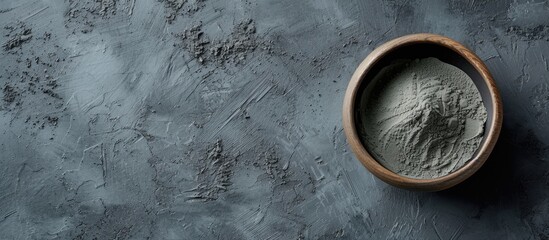 Blue gray bentonite clay in the bowl Clay texture close up Diy mask and body wrap recipe Natural beauty treatment and spa Top view copy space. with copy space image. Place for adding text or design